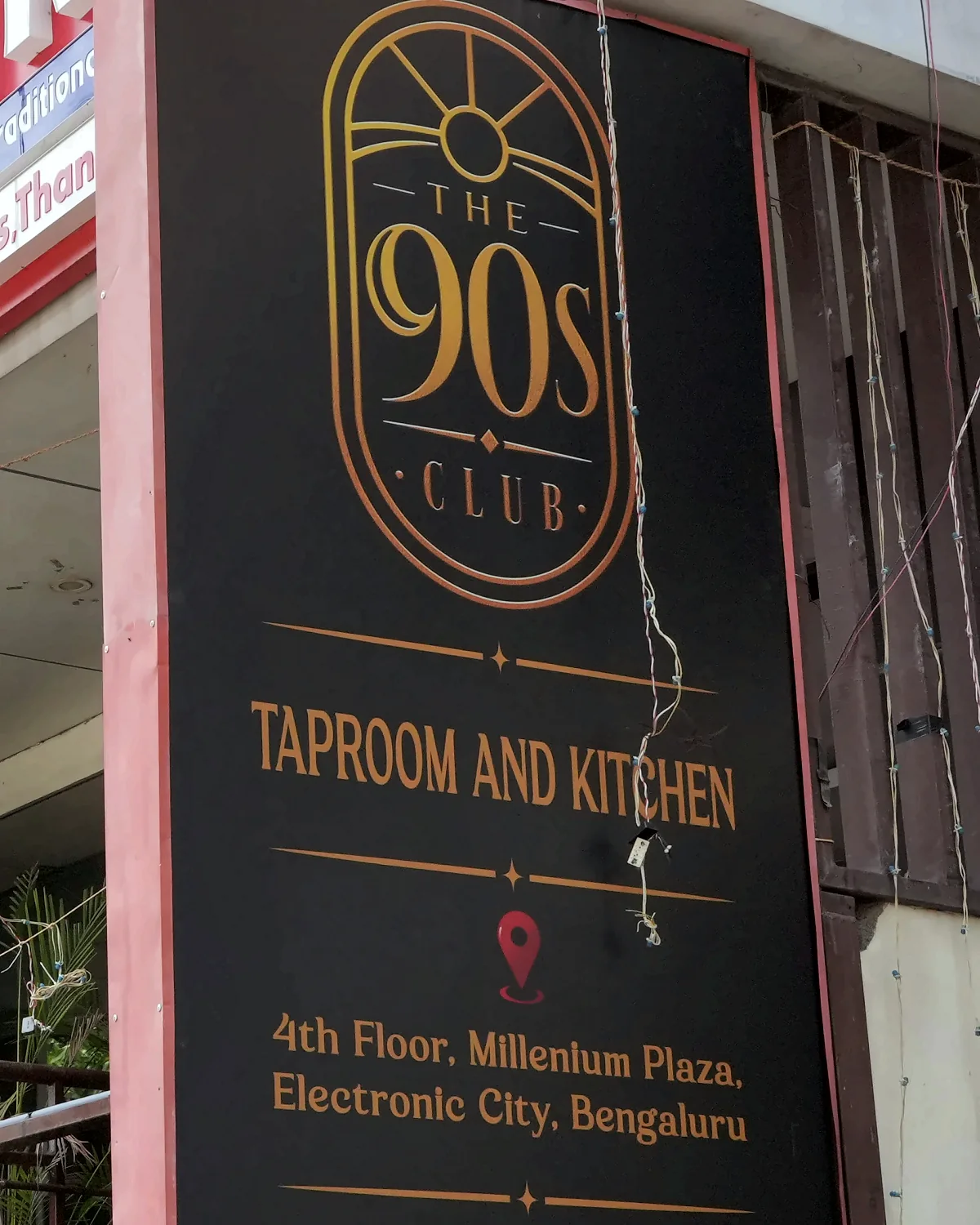The 90s Club Taproom and Kitchen signboard at Millennium Plaza, Electronic City, Bengaluru.